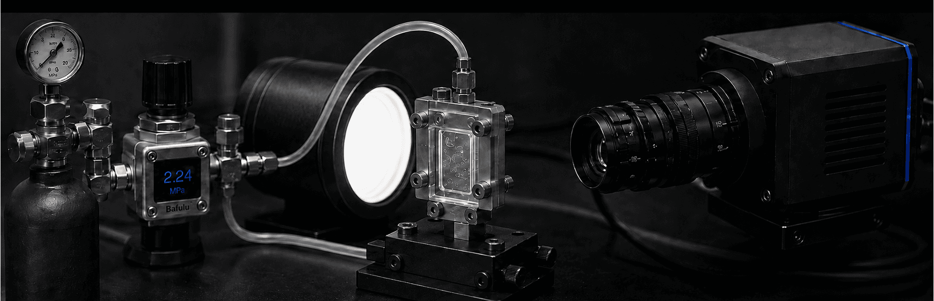 Pressure-driven high-speed imaging test rig, showing the gas cylinder, pressure regulator, backlight, packaged silicon-glass reactor and high-speed camera